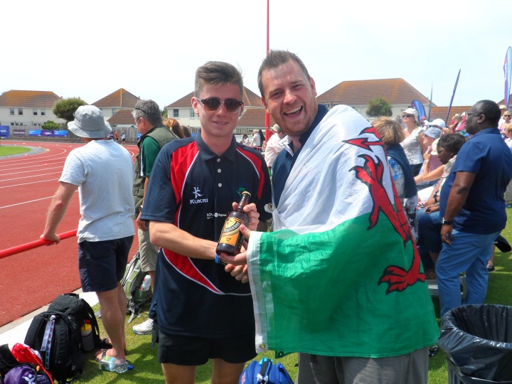 Iolo receiving a bottle of Mersea Island Beer from Pete